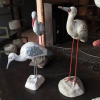 Series of storks in cement