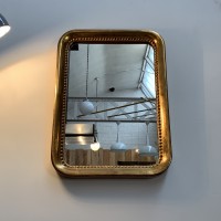 Mirror in golden stucco wood with gold leaf.