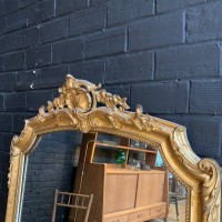 Large antique mirror in wood and gilded stucco